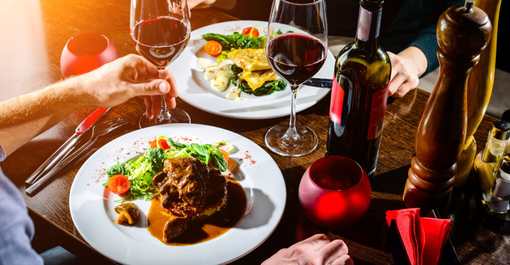 Elegant dinner setting with wine and gourmet dishes.
