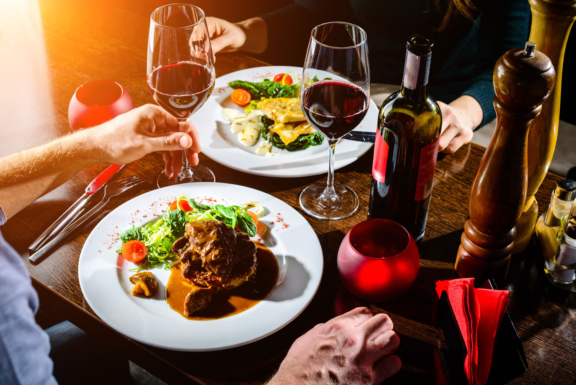 Elegant dinner setting with wine and gourmet dishes.