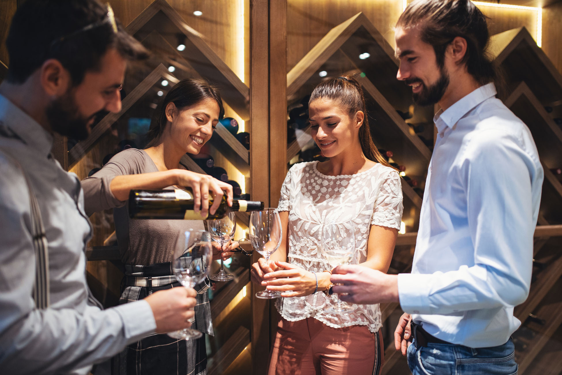 Friends enjoying wine tasting in an intimate cellar setting.